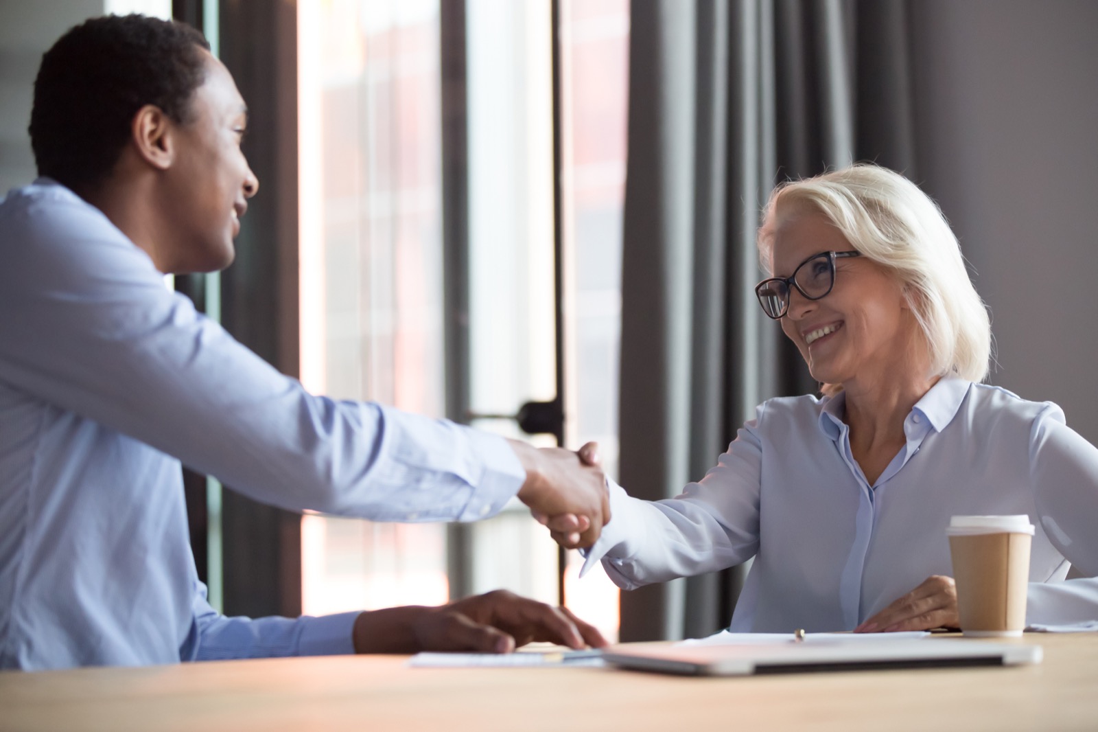 Happy businesswoman shaking hands with a therapist