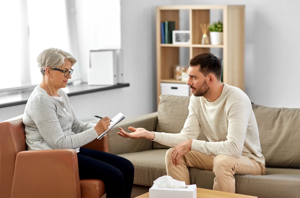 Man talking to therapist on couch